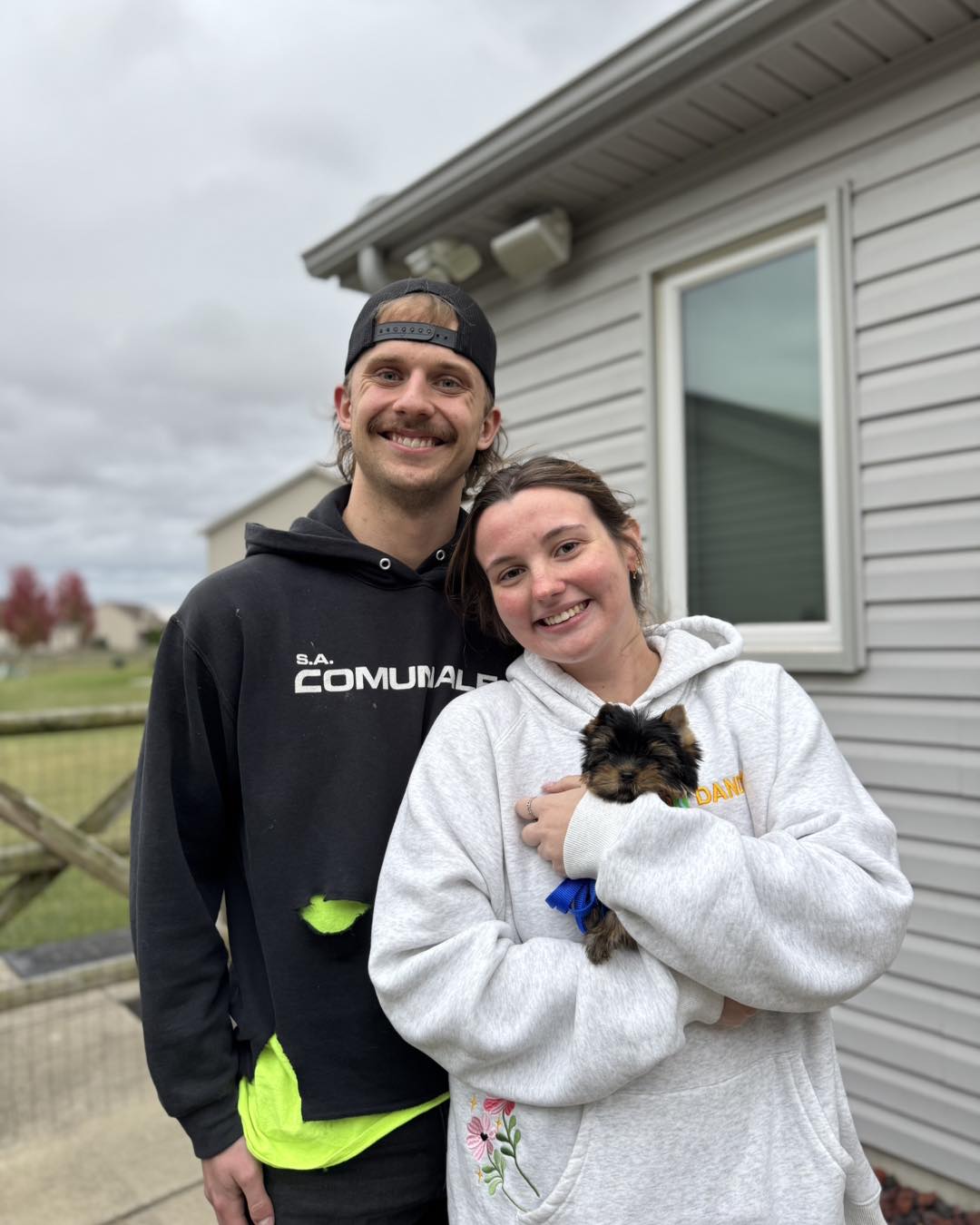 Happy family with their Yorkie puppy
